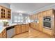 Bright kitchen featuring stainless steel double oven, countertops, and light wood cabinets at 1285 Rivershyre Pkwy, Lawrenceville, GA 30043