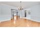 Spacious living room featuring hardwood floors, open entryway, and view into other rooms of the house at 1285 Rivershyre Pkwy, Lawrenceville, GA 30043