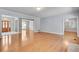 Spacious living room featuring shiny hardwood floors, white trim, and architectural columns to the entry and other rooms at 1285 Rivershyre Pkwy, Lawrenceville, GA 30043