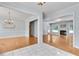 Bright and airy living space with fireplace, hardwood floors, and open doorway at 1285 Rivershyre Pkwy, Lawrenceville, GA 30043