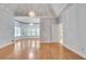 Large main bedroom featuring tray ceilings, hardwood floors, many windows, access to main bathroom, and a chandelier at 1285 Rivershyre Pkwy, Lawrenceville, GA 30043
