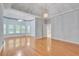 Large main bedroom featuring tray ceilings, hardwood floors, many windows, access to main bathroom, and ceiling fan at 1285 Rivershyre Pkwy, Lawrenceville, GA 30043