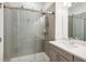 Modern bathroom featuring grey tile walls, glass enclosed shower, and a white vanity at 2034 Rockledge Ne Rd, Atlanta, GA 30324