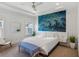 Bright bedroom featuring a tray ceiling, modern ceiling fan, and a striking blue accent wall for visual appeal at 2034 Rockledge Ne Rd, Atlanta, GA 30324