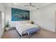 Bedroom featuring a tray ceiling, ceiling fan and modern, colorful art above the bed at 2034 Rockledge Ne Rd, Atlanta, GA 30324