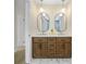 Renovated bathroom featuring a double vanity, marble countertop, and modern light fixtures at 4376 Riverwood Cir, Decatur, GA 30035