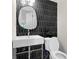 Chic bathroom with modern fixtures, black tiling and a unique mirror at 4376 Riverwood Cir, Decatur, GA 30035