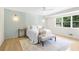 Stylish bedroom with accent wall, decorative sconces, and hardwood floors at 4376 Riverwood Cir, Decatur, GA 30035