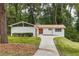 Charming, ranch-style home with brick accents, mature trees, and a well-manicured lawn at 4376 Riverwood Cir, Decatur, GA 30035