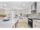 Elegant kitchen with white cabinets, stainless steel appliances, and a large island at 4376 Riverwood Cir, Decatur, GA 30035