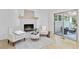 Bright living area with fireplace, neutral tones, and access to sunroom at 4376 Riverwood Cir, Decatur, GA 30035