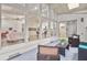 Covered patio featuring wicker furniture and views into the home through the floor to ceiling windows at 4376 Riverwood Cir, Decatur, GA 30035