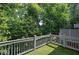 Outdoor balcony area with artificial turf and railing overlooking lush greenery at 5492 Glenridge Dr # 536, Atlanta, GA 30342