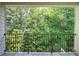 Outdoor balcony with black metal railing and serene wooded views at 5492 Glenridge Dr # 536, Atlanta, GA 30342