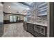 Basement bar with stone accents, shelving, sink, and appliances at 5492 Glenridge Dr # 536, Atlanta, GA 30342