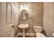 Stylish half bathroom featuring elegant wallpaper, a pedestal sink, and a classic toilet at 5492 Glenridge Dr # 536, Atlanta, GA 30342