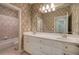 Bathroom featuring double vanity, decorative wallpaper, and bathtub with shower at 5492 Glenridge Dr # 536, Atlanta, GA 30342