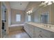 Bathroom with a large vanity, double sinks, granite countertop, and large soaking tub at 5492 Glenridge Dr # 536, Atlanta, GA 30342