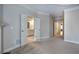Spacious bedroom with neutral tones, carpeted flooring, and double doors leading to the en suite bathroom at 5492 Glenridge Dr # 536, Atlanta, GA 30342