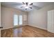 Bedroom with wood floors, ceiling fan, and French doors leading to the outside at 5492 Glenridge Dr # 536, Atlanta, GA 30342