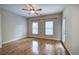Spacious bedroom with wood floors, ceiling fan, and natural light at 5492 Glenridge Dr # 536, Atlanta, GA 30342