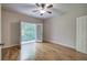 Bedroom with wood floors, ceiling fan, and French doors leading to the outside at 5492 Glenridge Dr # 536, Atlanta, GA 30342