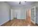 Bedroom featuring wood floors, multiple entry doors, and closet at 5492 Glenridge Dr # 536, Atlanta, GA 30342