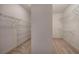 Walk-in closet with wire shelving and neutral carpeting, offering ample storage space at 5492 Glenridge Dr # 536, Atlanta, GA 30342