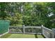 Outdoor deck area with artificial turf and railing overlooking trees at 5492 Glenridge Dr # 536, Atlanta, GA 30342