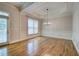 Spacious dining room with a tray ceiling, hardwood floors, natural light, and access to the patio at 5492 Glenridge Dr # 536, Atlanta, GA 30342