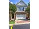 Townhome with a two-car garage and a well-manicured lawn, showcasing a charming facade at 5492 Glenridge Dr # 536, Atlanta, GA 30342