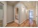 Hallway featuring hardwood floors, decorative sconces, and bathroom and bedroom doorways at 5492 Glenridge Dr # 536, Atlanta, GA 30342