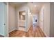 Hallway with hardwood floors leading to a full bathroom and other living areas at 5492 Glenridge Dr # 536, Atlanta, GA 30342