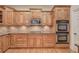 Gourmet kitchen showcasing custom wood cabinets, granite counters, and a suite of stainless steel appliances at 5492 Glenridge Dr # 536, Atlanta, GA 30342