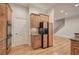 Gourmet kitchen showcasing custom wood cabinets, a black refrigerator and stainless steel double ovens at 5492 Glenridge Dr # 536, Atlanta, GA 30342
