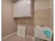 Laundry room with sink, upper cabinets, and wire shelving for storage at 5492 Glenridge Dr # 536, Atlanta, GA 30342