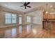 Open-concept living room featuring hardwood floors, large windows, and a seamless transition to the dining area and kitchen at 5492 Glenridge Dr # 536, Atlanta, GA 30342