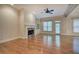 Open living room with hardwood floors, fireplace, built-in shelving, and access to the outdoor patio at 5492 Glenridge Dr # 536, Atlanta, GA 30342