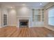 Inviting living room with hardwood floors, a fireplace, built-in shelving, and plenty of natural light at 5492 Glenridge Dr # 536, Atlanta, GA 30342