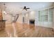 Bright living room boasts hardwood floors, a fireplace, built-in shelving, and a ceiling fan at 5492 Glenridge Dr # 536, Atlanta, GA 30342
