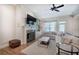 Cozy living room with hardwood floors, fireplace, built-in shelves, and comfortable seating arrangement at 5492 Glenridge Dr # 536, Atlanta, GA 30342