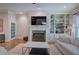 Comfortable living room with a fireplace, built-in shelves, and natural light from a large window at 5492 Glenridge Dr # 536, Atlanta, GA 30342