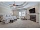 Spacious main bedroom boasts a tray ceiling, fireplace, and sitting area at 5492 Glenridge Dr # 536, Atlanta, GA 30342