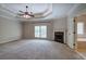 Expansive main bedroom featuring a fireplace, tray ceiling, and bathroom entrance at 5492 Glenridge Dr # 536, Atlanta, GA 30342