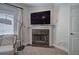 Cozy fireplace in the main bedroom with seating area and window with plantation shutters at 5492 Glenridge Dr # 536, Atlanta, GA 30342
