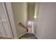 Carpeted staircase with wooden handrail leads to the home's lower level at 5492 Glenridge Dr # 536, Atlanta, GA 30342