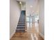 Carpeted staircase leading to an open floor plan with hardwood floors at 5492 Glenridge Dr # 536, Atlanta, GA 30342