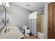 Bathroom with a vanity, mirror, toilet, and shower with a striped curtain at 2041 Millspring Nw Way, Kennesaw, GA 30152