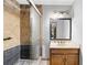 Updated bathroom with a tiled shower, glass door, and wood vanity with stylish lighting at 2041 Millspring Nw Way, Kennesaw, GA 30152