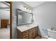 Bathroom with a vanity, large mirror, toilet, and a shower with a striped curtain visible in the reflection at 2041 Millspring Nw Way, Kennesaw, GA 30152